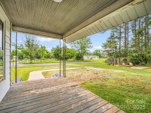 a view of empty room with wooden floor and windows