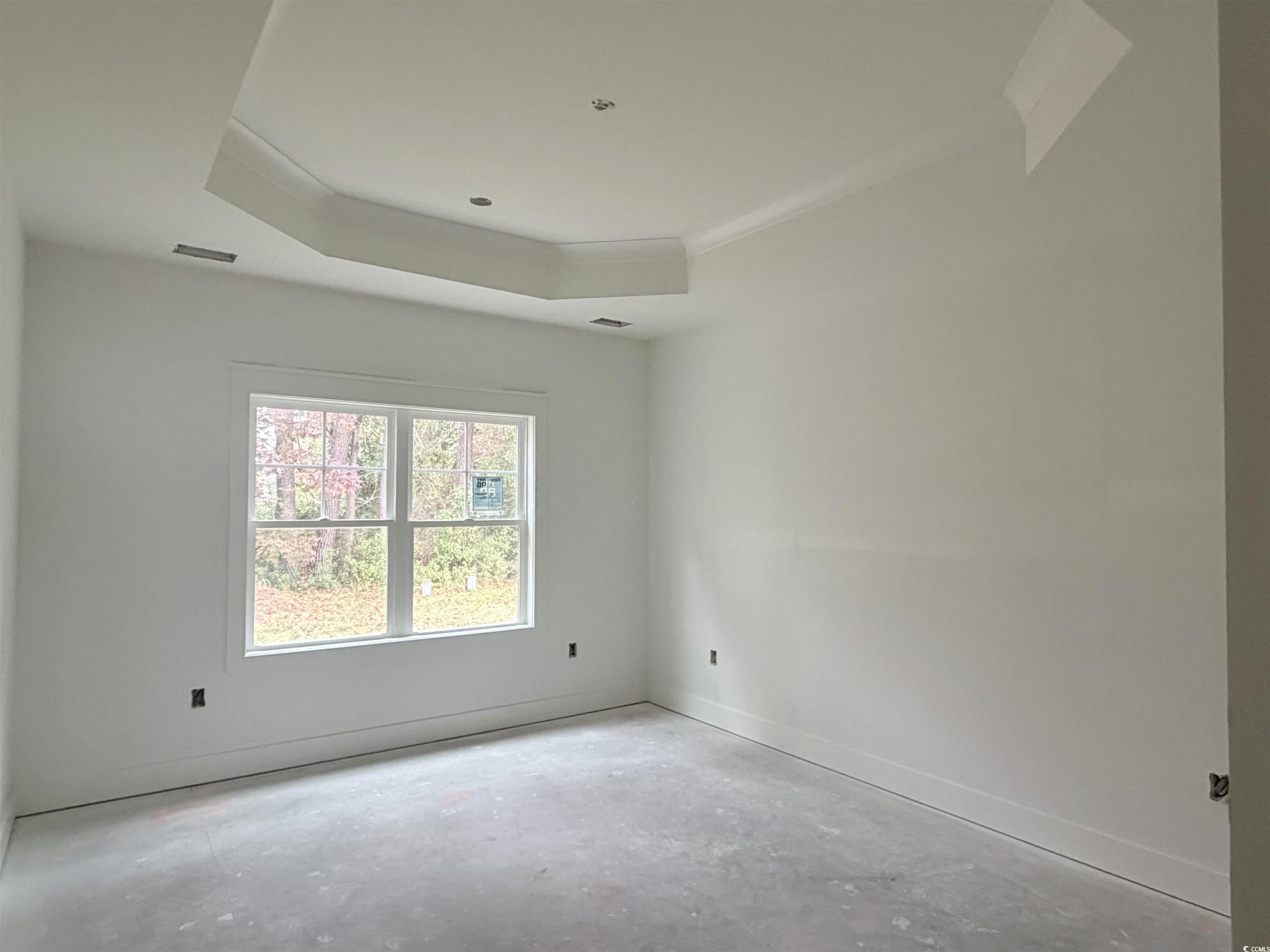 Ben Horry Trail Pawleys Island, SC 29585 - Photo 36 of 37 Unfurnished room featuring a raised ceiling and unfinished concrete flooring