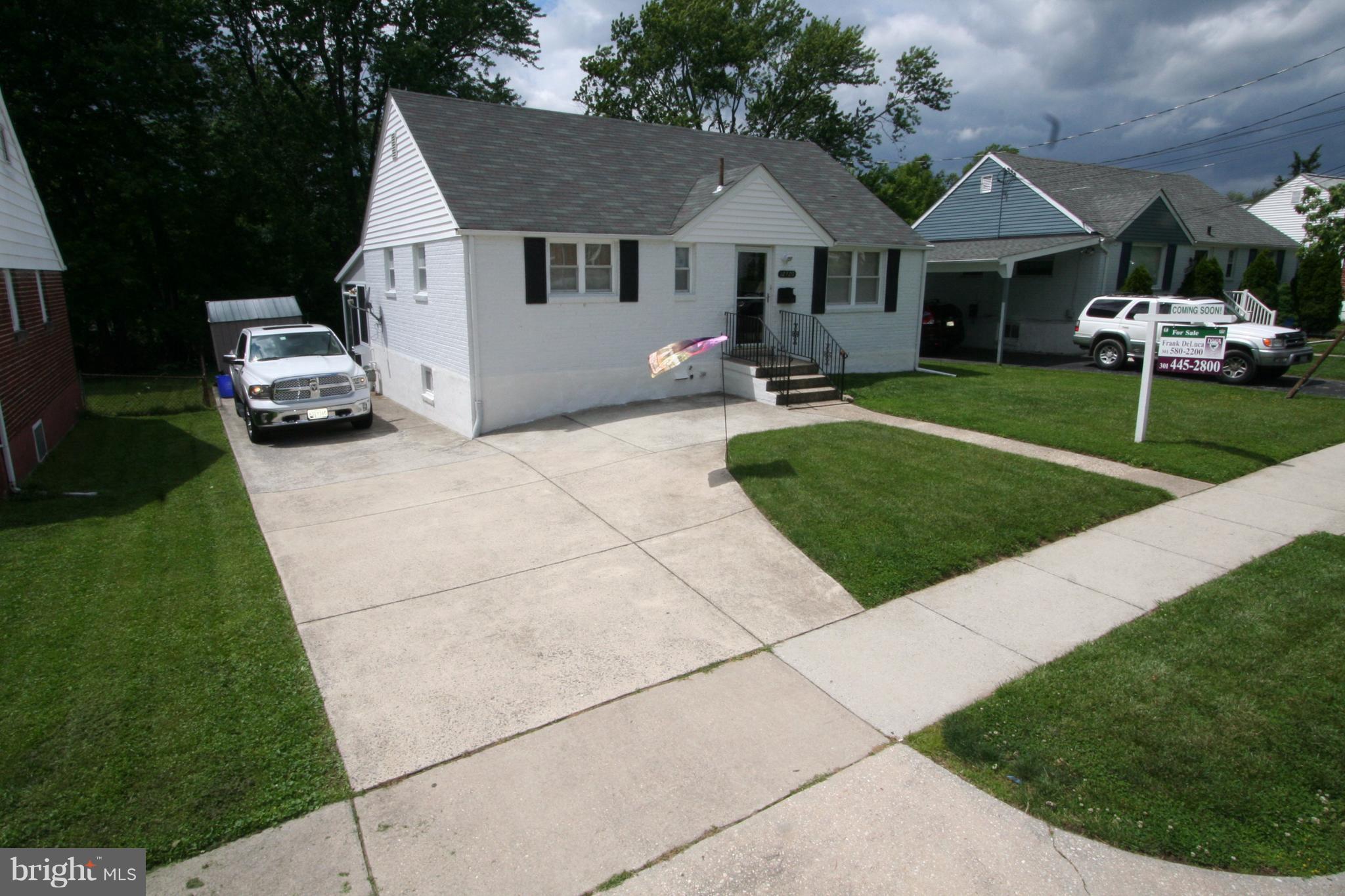12720 Gould Road Silver Spring, MD 20906 - Photo 2 of 30 a front view of a house with a garden and trees