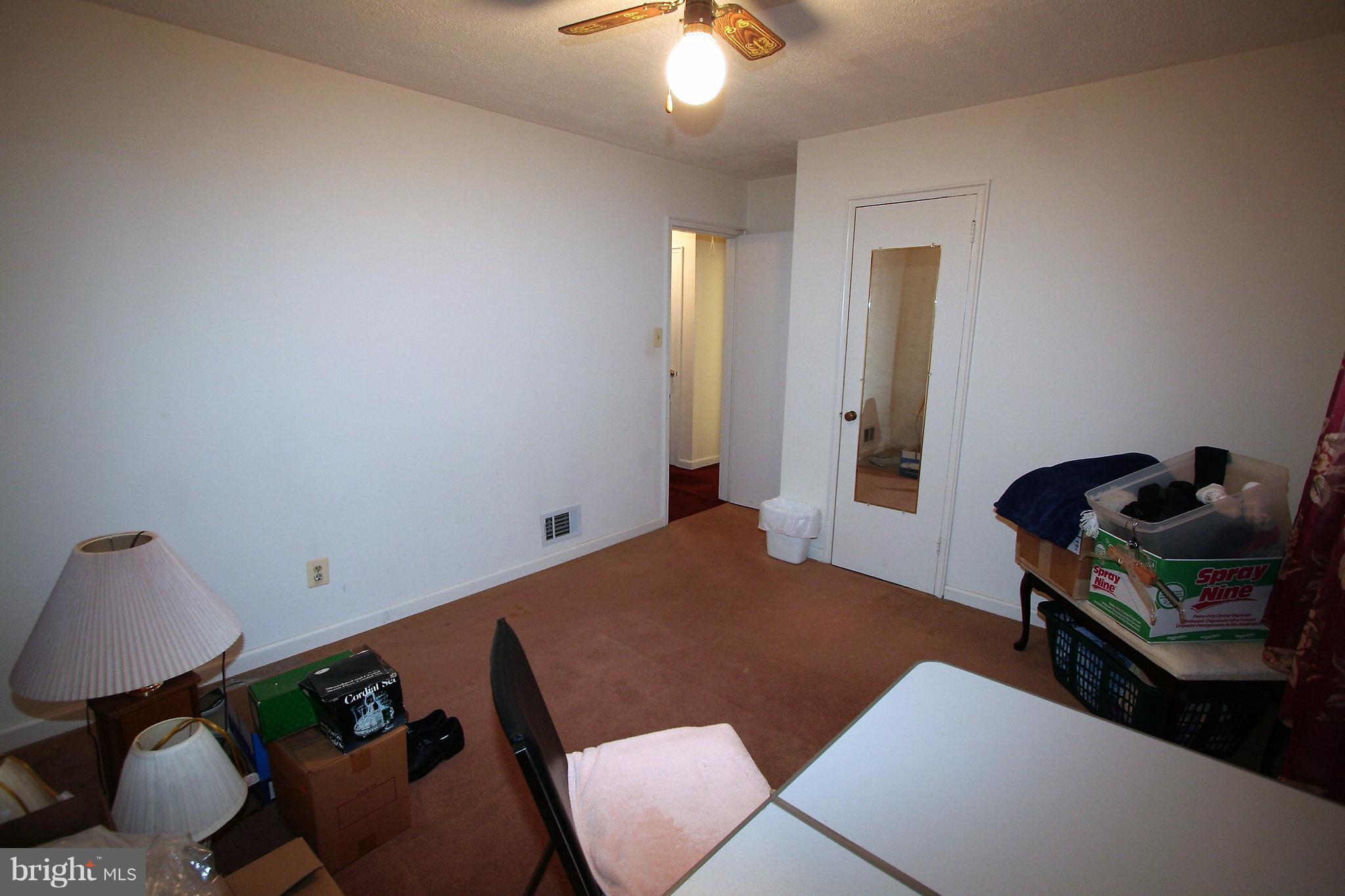 12720 Gould Road Silver Spring, MD 20906 - Photo 11 of 30 a bedroom with furniture and a chandelier fan