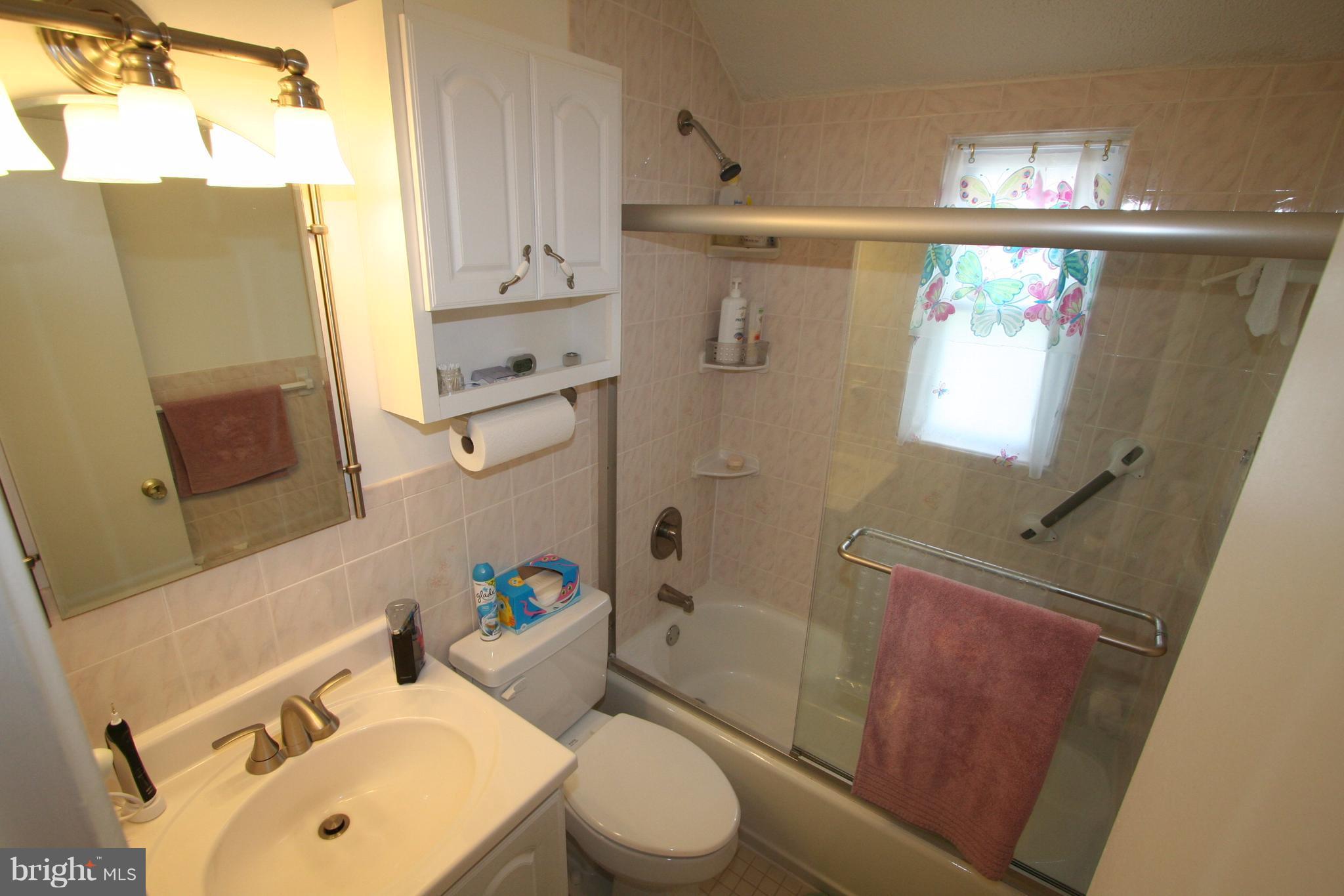 12720 Gould Road Silver Spring, MD 20906 - Photo 13 of 30 a bathroom with a sink mirror vanity and toilet