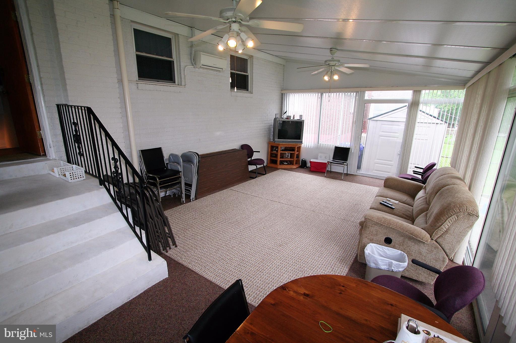 12720 Gould Road Silver Spring, MD 20906 - Photo 15 of 30 a living room with furniture and a flat screen tv