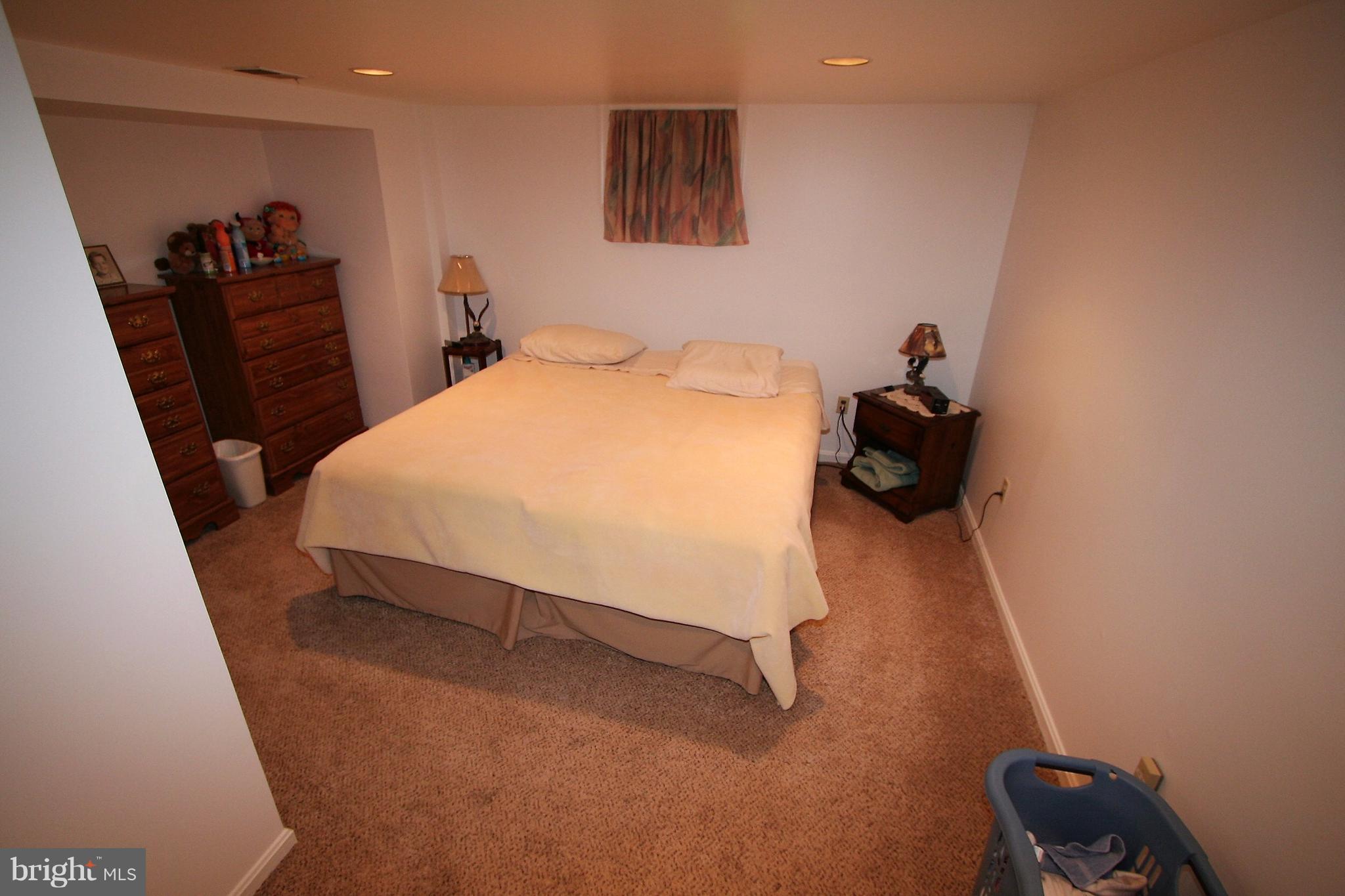 12720 Gould Road Silver Spring, MD 20906 - Photo 18 of 30 a bedroom with a bed and a furniture