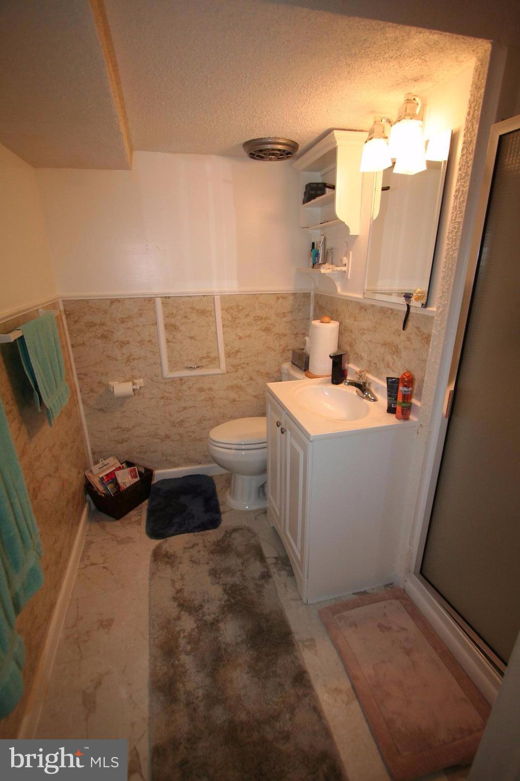 12720 Gould Road Silver Spring, MD 20906 - Photo 21 of 30 a bathroom with a sink a toilet and shower