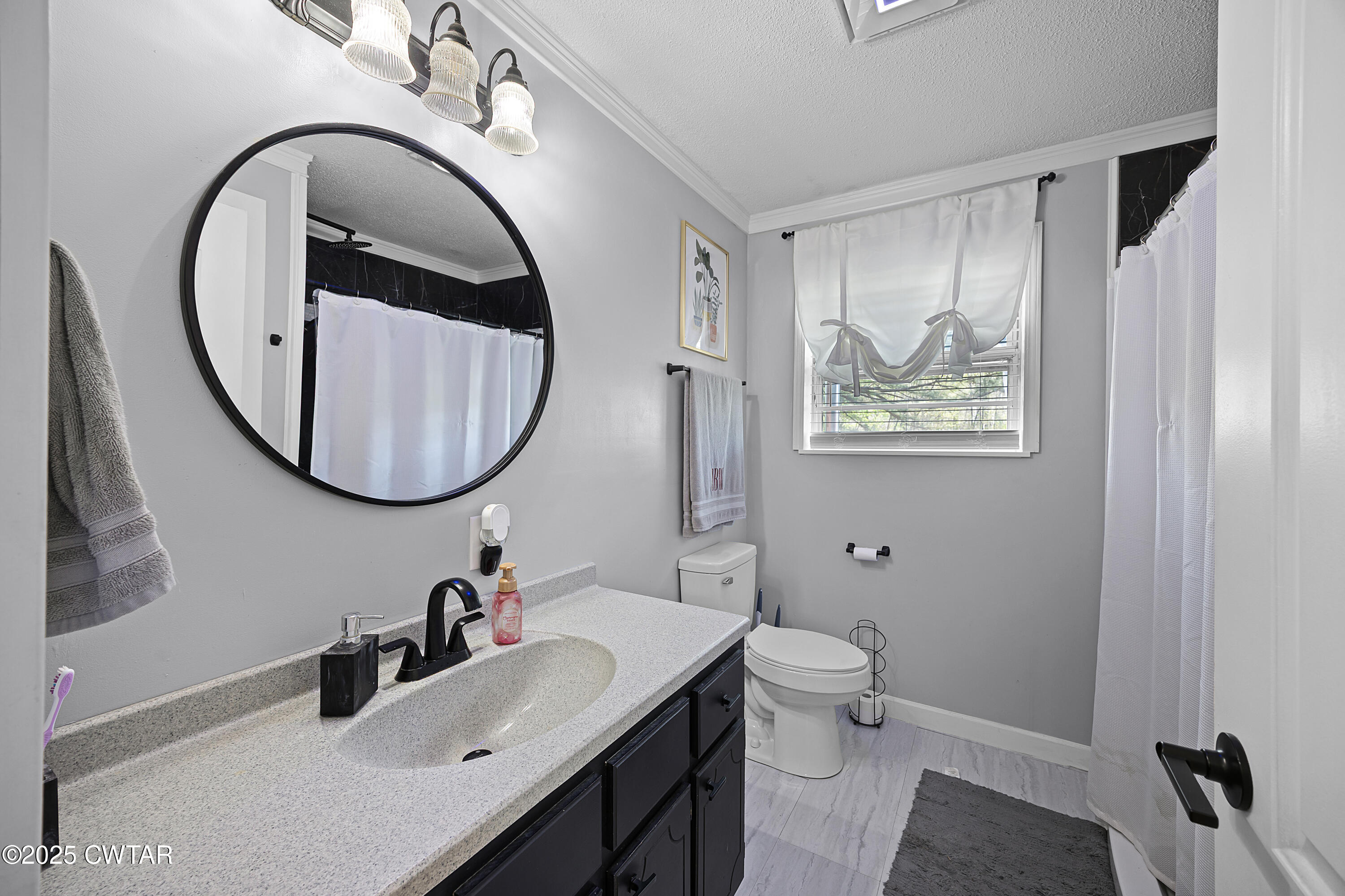 34 Hughes Loop Milan, TN 38358 - Photo 12 of 21 a bathroom with a granite countertop toilet a sink and a mirror