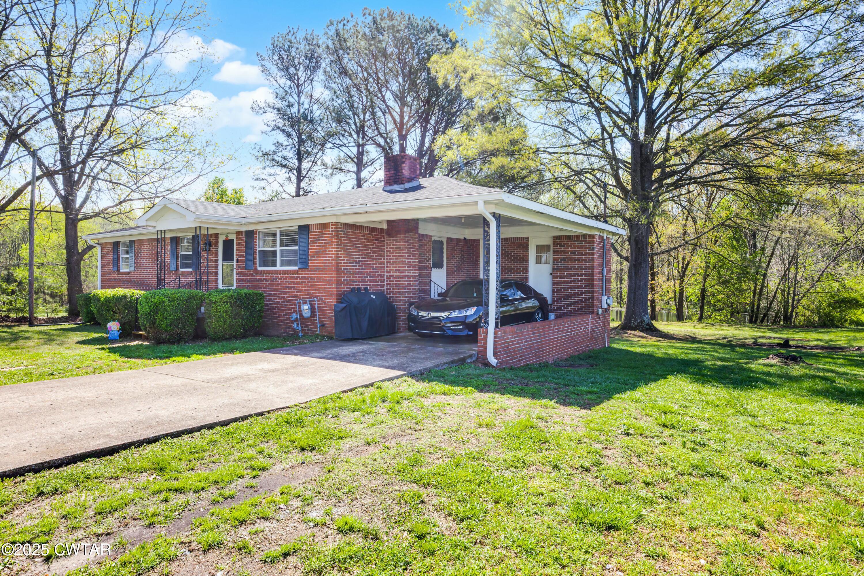 34 Hughes Loop Milan, TN 38358 - Photo 2 of 21 a view of a house with backyard and a tree