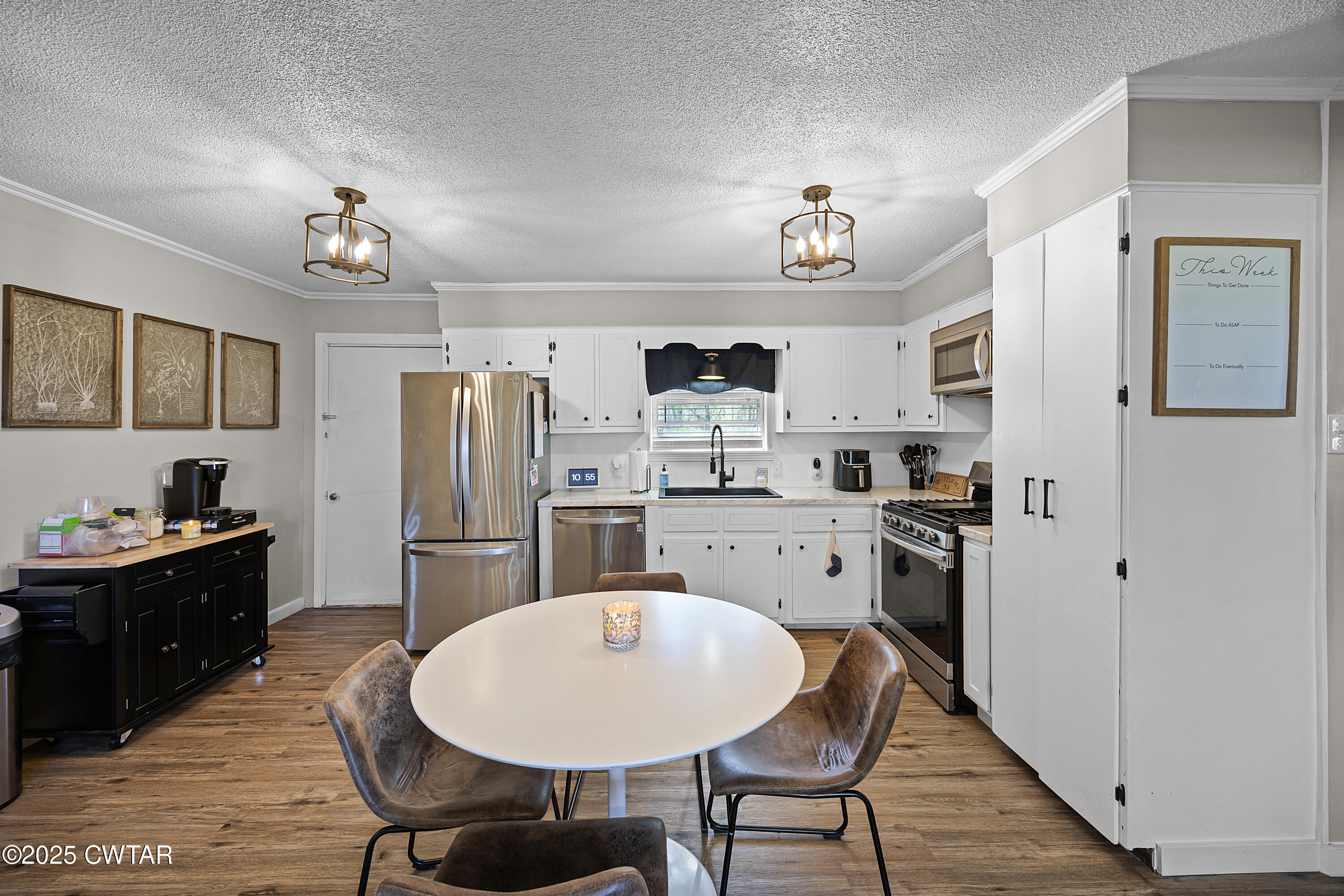 34 Hughes Loop Milan, TN 38358 - Photo 6 of 21 a kitchen with refrigerator cabinets dining table and chairs