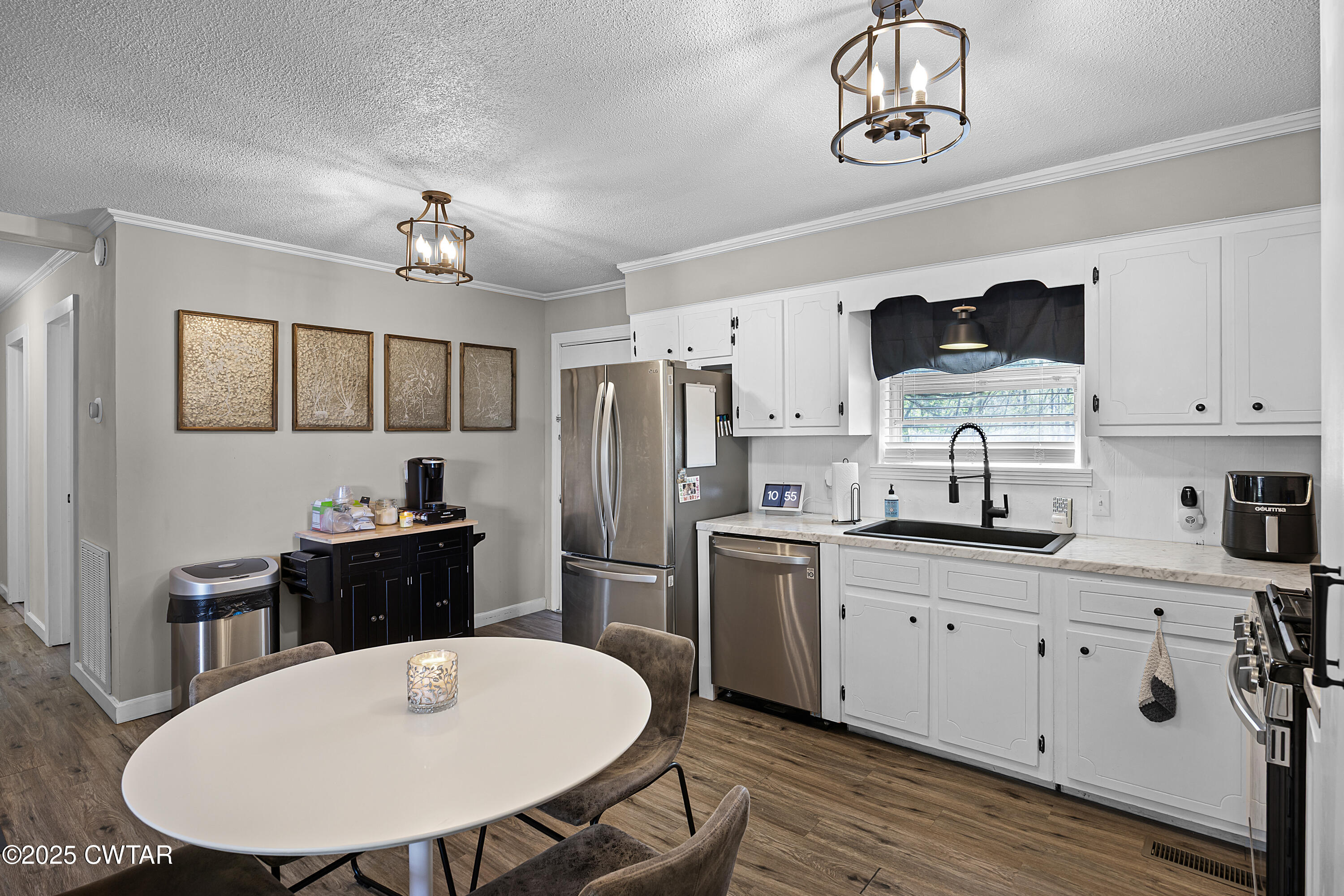 34 Hughes Loop Milan, TN 38358 - Photo 8 of 21 a kitchen with stainless steel appliances a kitchen island a stove a table and chairs