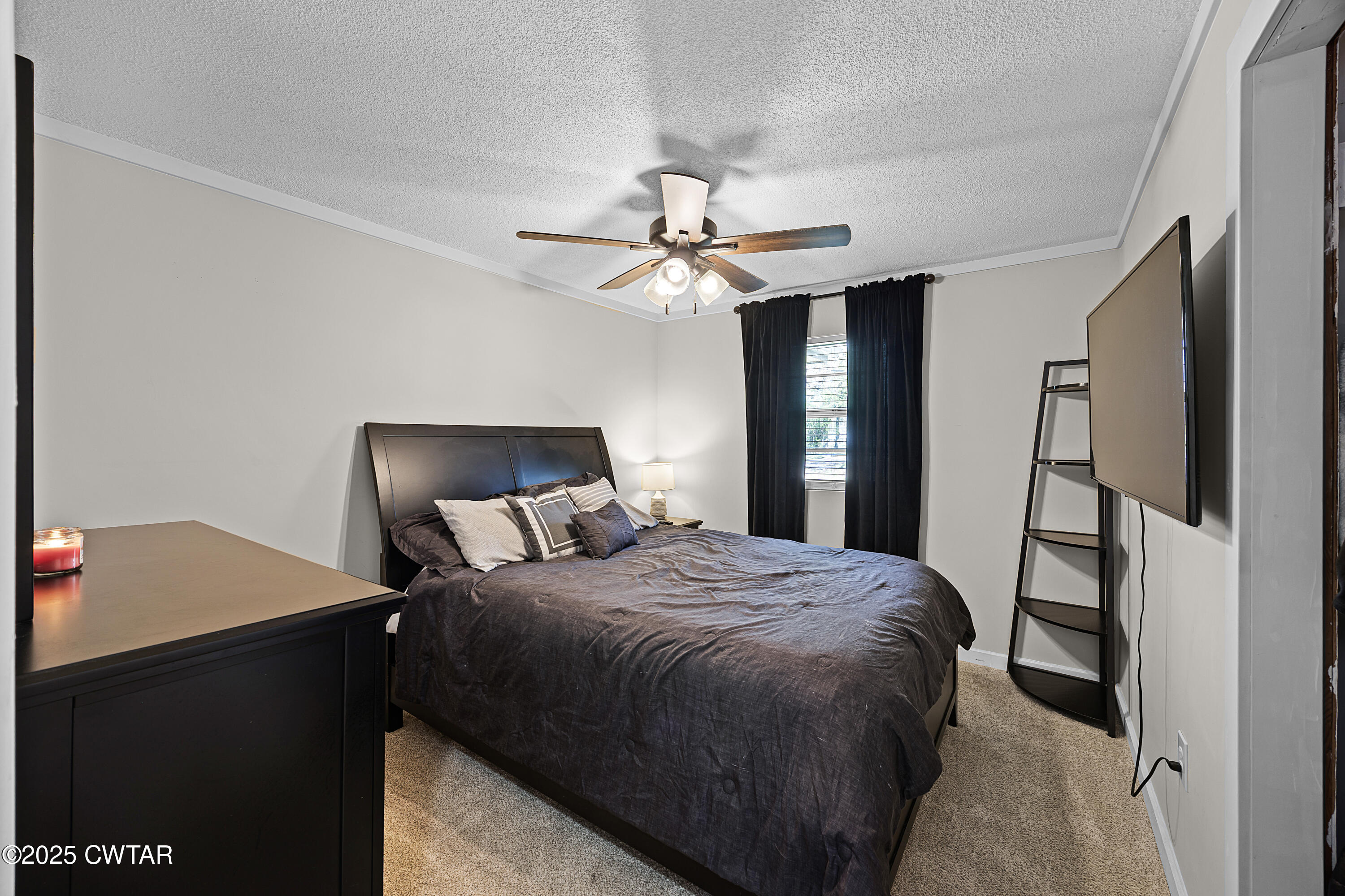 34 Hughes Loop Milan, TN 38358 - Photo 9 of 21 a bedroom with a bed and a ceiling fan