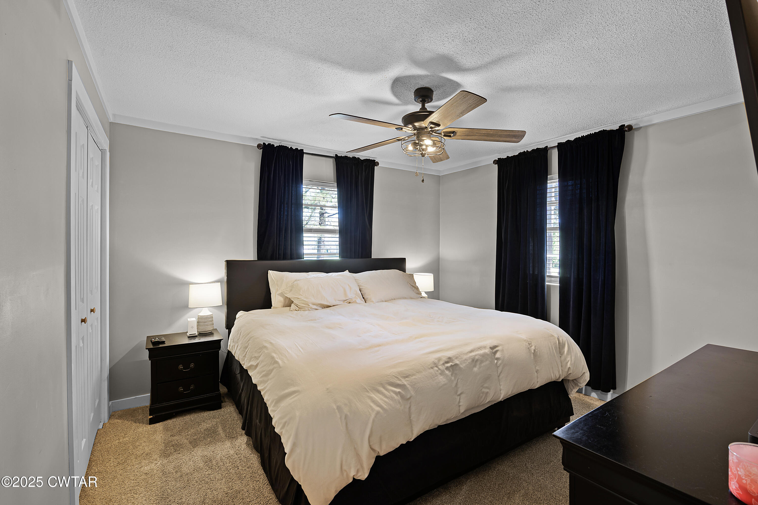 34 Hughes Loop Milan, TN 38358 - Photo 10 of 21 a bedroom with a bed and a chandelier