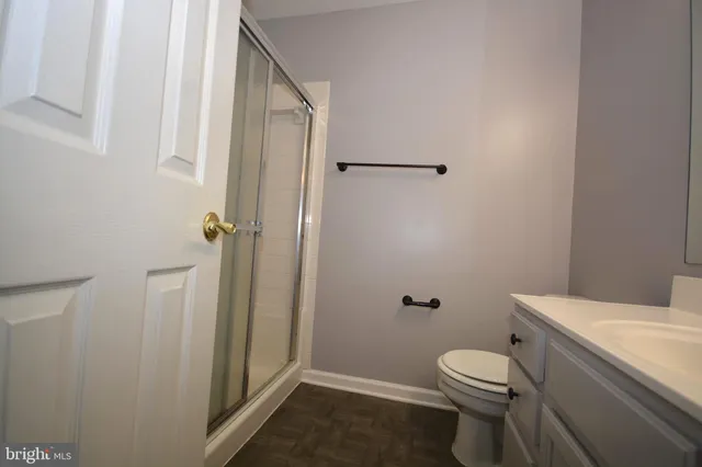 a white toilet sitting next to a shower