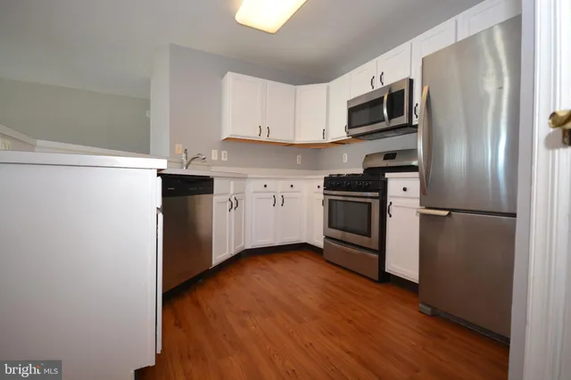 a kitchen with stainless steel appliances a refrigerator stove and microwave