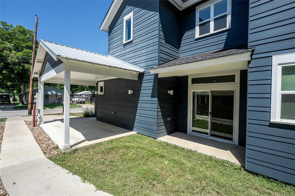 2821 Castro Street, Unit 1 Austin, TX 78702 - Photo 20 of 21 Contemporary exterior featuring horizontal siding, a covered carport with a metal roof, and a ground-floor sliding glass door