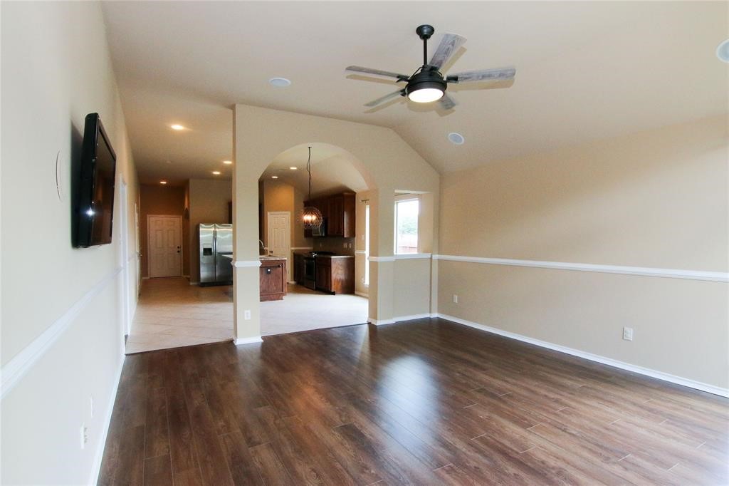 27431 Rebecca Field Lane Spring, TX 77386 - Photo 12 of 26 a view of a living room with wooden floor and a ceiling fan
