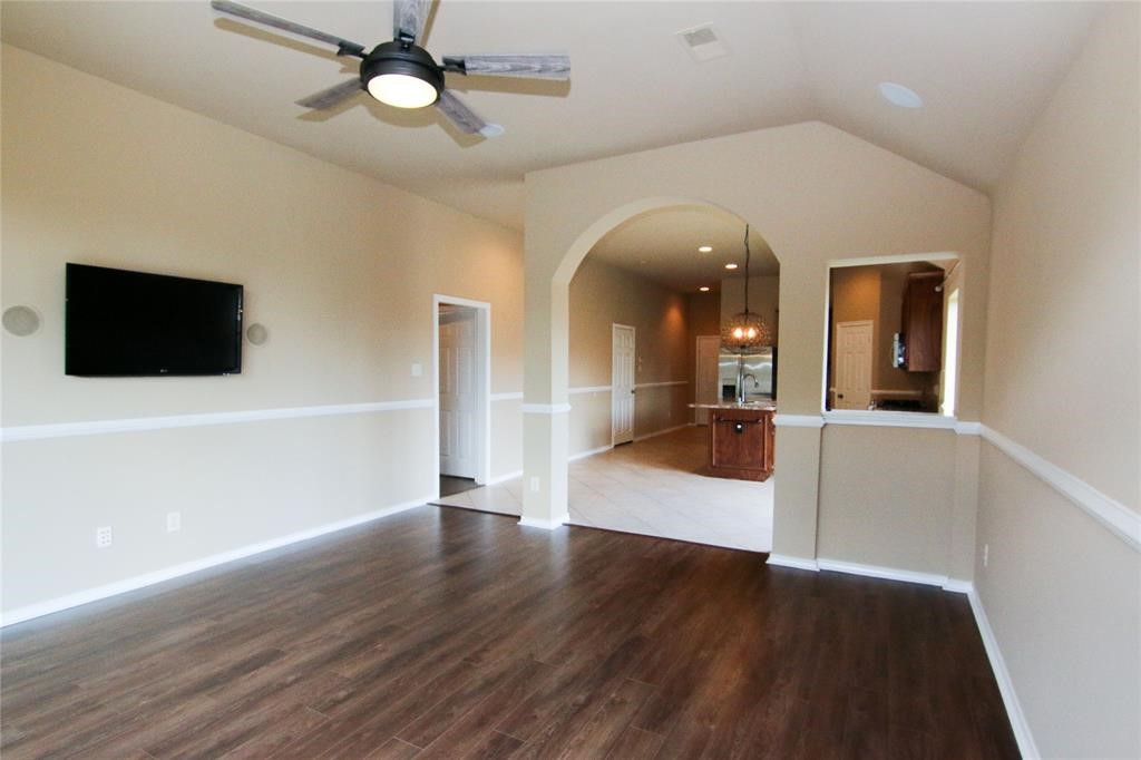 27431 Rebecca Field Lane Spring, TX 77386 - Photo 13 of 26 a view of a living room with hardwood floor and a ceiling fan