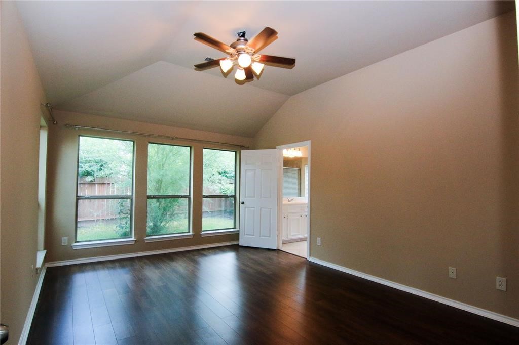 27431 Rebecca Field Lane Spring, TX 77386 - Photo 15 of 26 a view of an empty room with wooden floor and a window