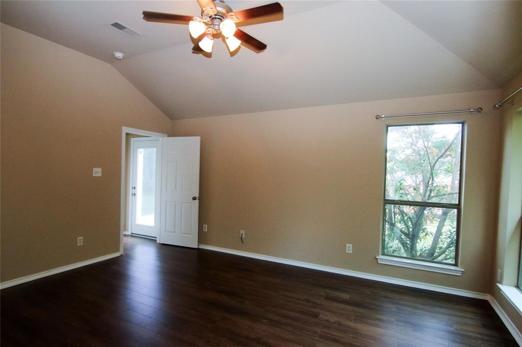 27431 Rebecca Field Lane Spring, TX 77386 - Photo 17 of 26 a view of an empty room with wooden floor and a window