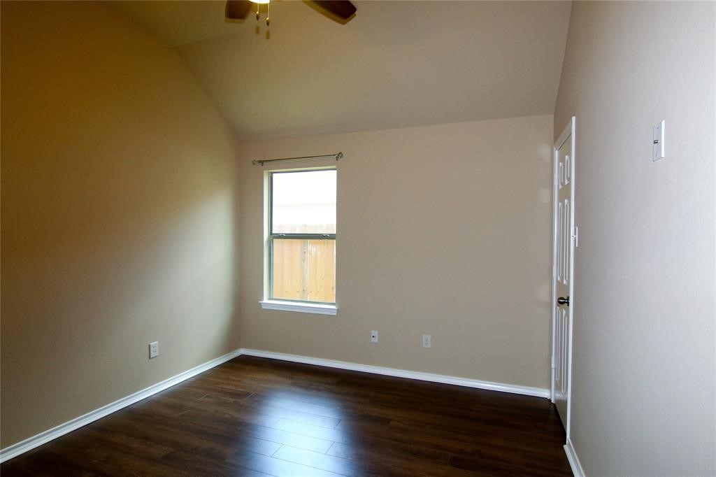 27431 Rebecca Field Lane Spring, TX 77386 - Photo 23 of 26 an empty room with wooden floor cabinet and windows