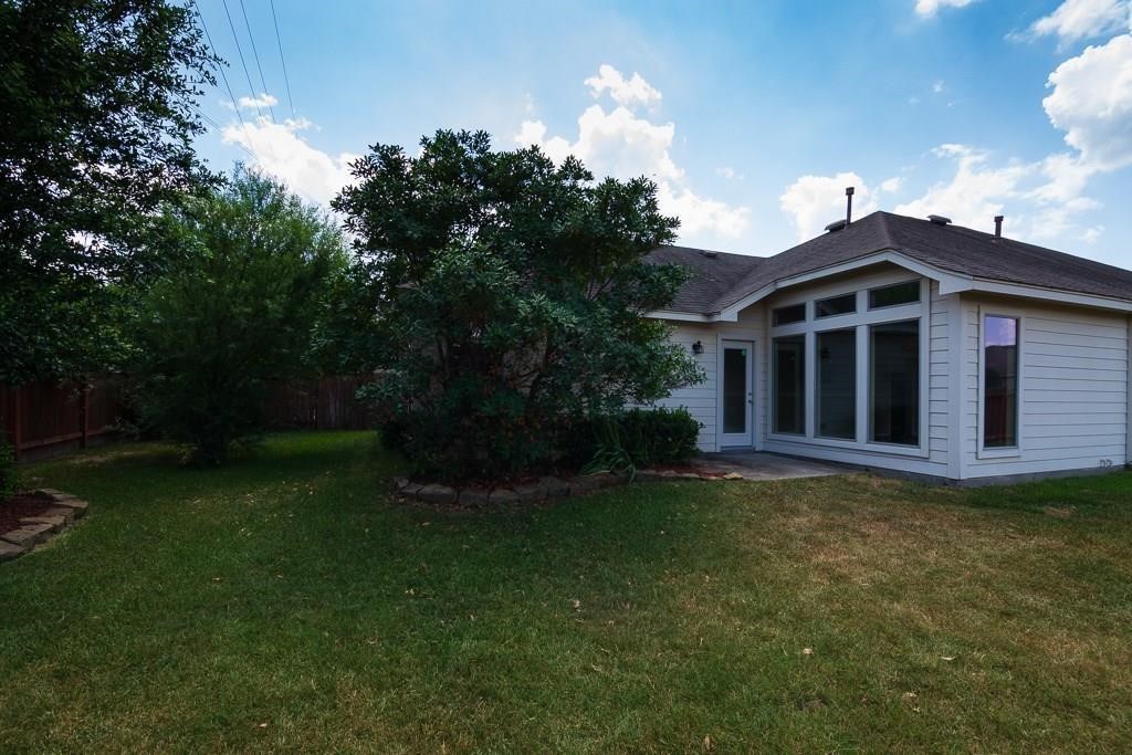 27431 Rebecca Field Lane Spring, TX 77386 - Photo 26 of 26 a front view of a house with garden