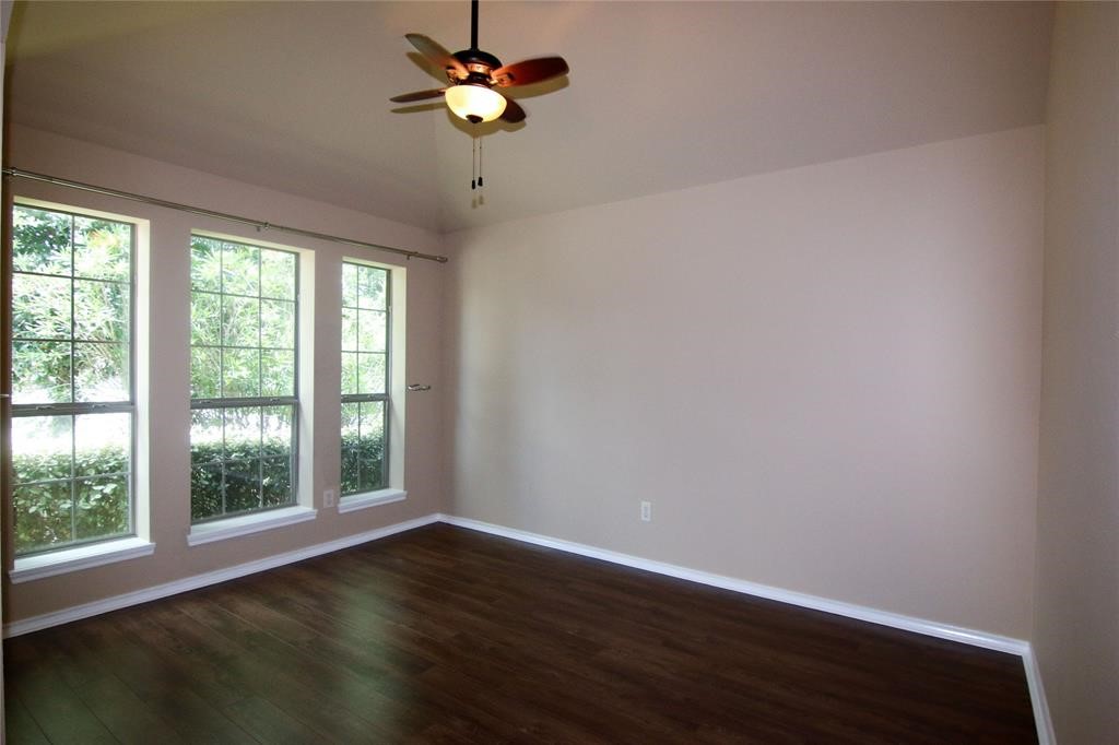 27431 Rebecca Field Lane Spring, TX 77386 - Photo 4 of 26 a view of room with hardwood floor and a ceiling fan