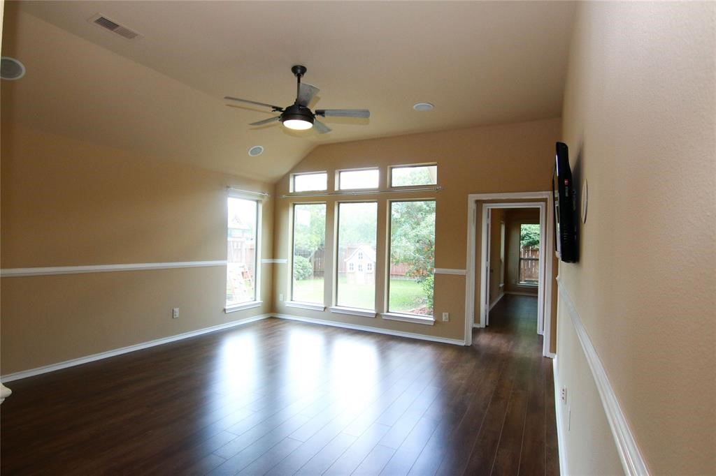 27431 Rebecca Field Lane Spring, TX 77386 - Photo 10 of 26 an empty room with wooden floor fan and windows