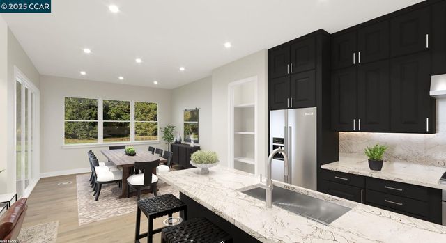 a kitchen with granite countertop sink refrigerator and table
