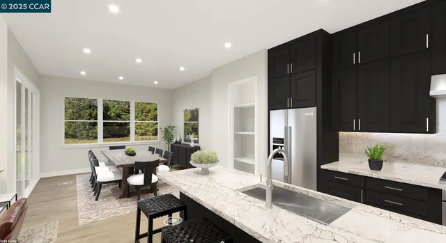 a kitchen with granite countertop sink refrigerator and table