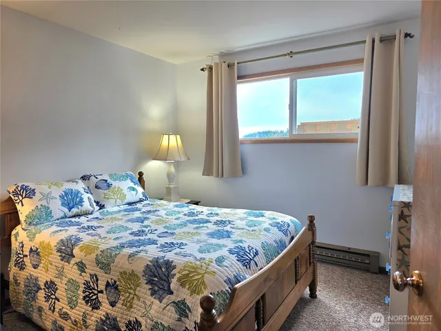 a bedroom with a bed and window