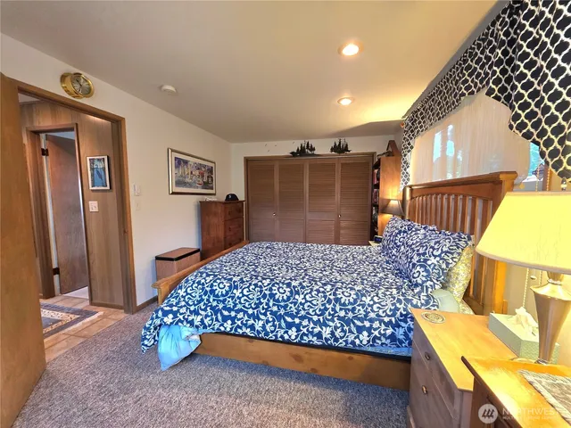 a bedroom with a bed and a dresser