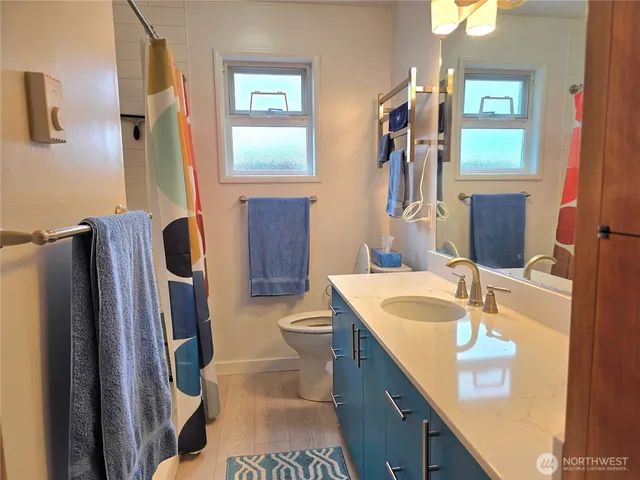 a bathroom with a sink a toilet and a mirror