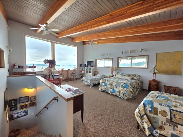 a bedroom with two beds and a couch