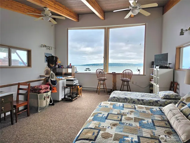 a bedroom with furniture and a large window
