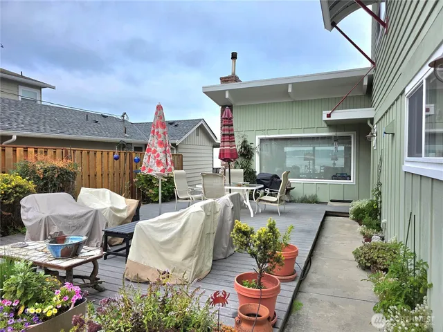 a view of a patio with couches table and chairs and potted plants