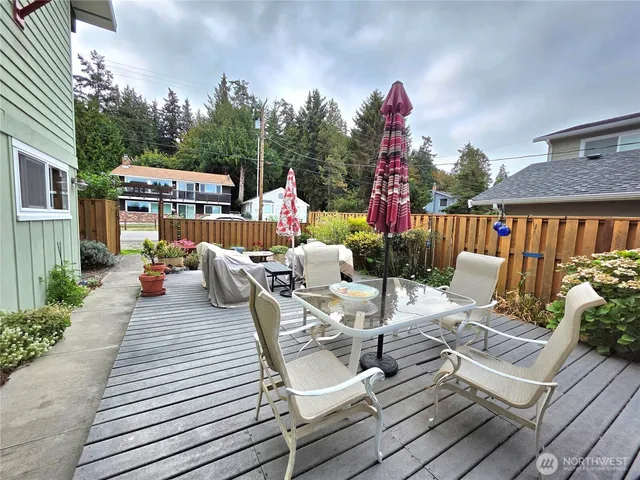 a view of a patio with furniture and a garden