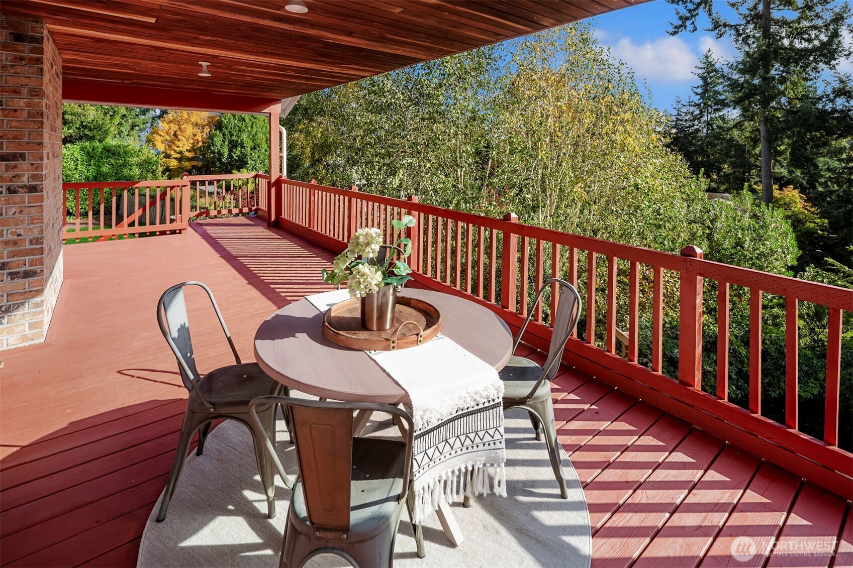 10514 Southwest 110th Street Vashon, WA 98070 - Photo 28 of 38 a view of a patio with table and chairs with wooden floor and fence