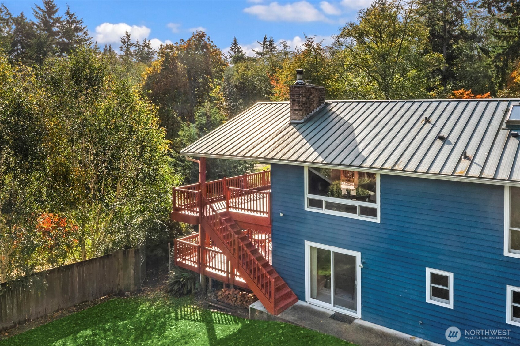 10514 Southwest 110th Street Vashon, WA 98070 - Photo 3 of 38 a front view of a house with a garden