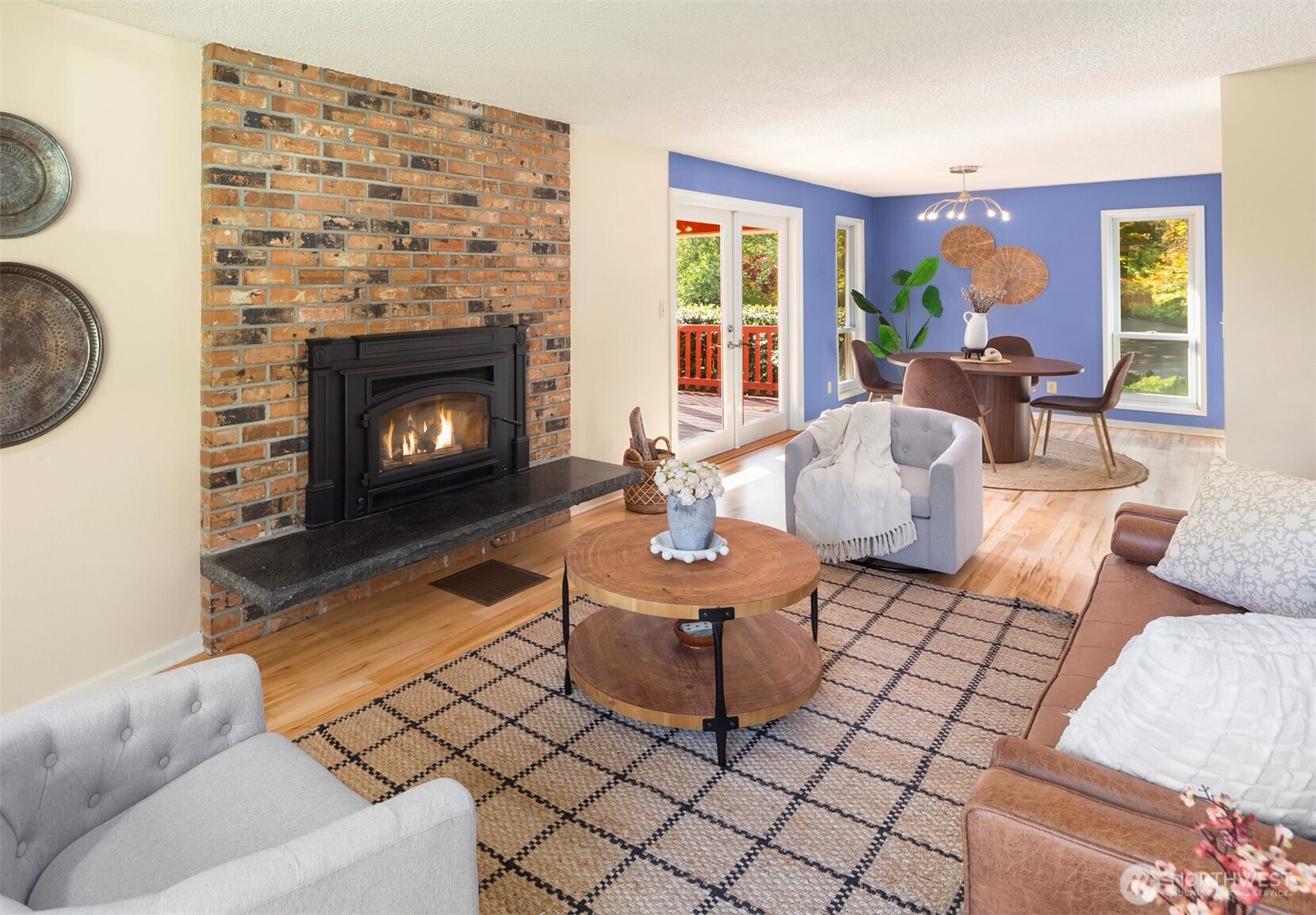 10514 Southwest 110th Street Vashon, WA 98070 - Photo 6 of 38 a living room with furniture a fireplace and a large window