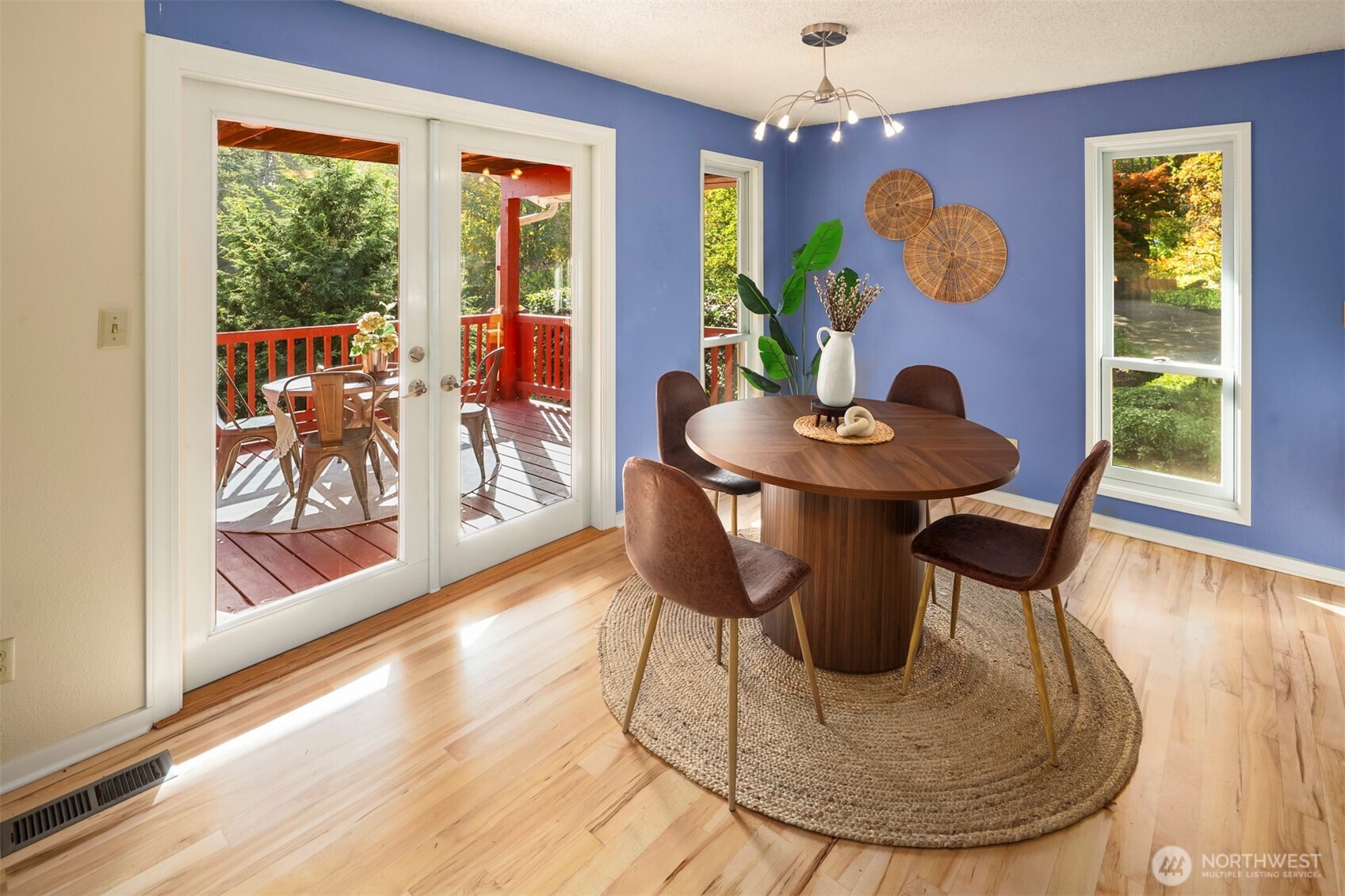10514 Southwest 110th Street Vashon, WA 98070 - Photo 7 of 38 a view of a dining room with furniture a chandelier and wooden floor