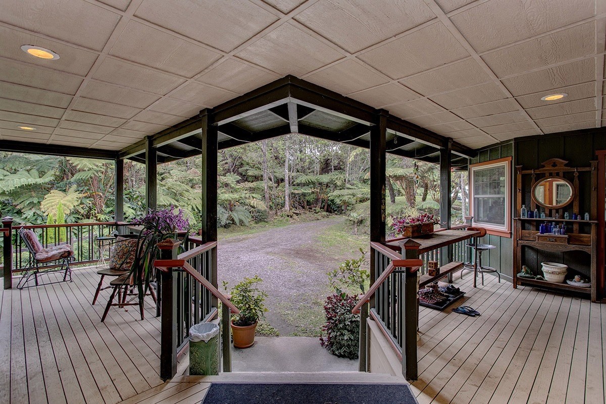 19-4242 Wright Road Volcano, HI 96785 - Photo 12 of 30 a view of a patio with table and chairs potted plants with wooden floor