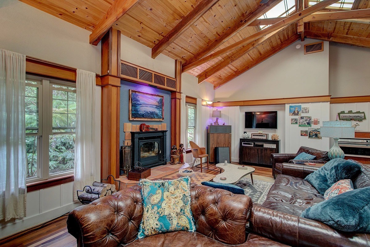 19-4242 Wright Road Volcano, HI 96785 - Photo 14 of 30 a living room with furniture a fireplace and a flat screen tv