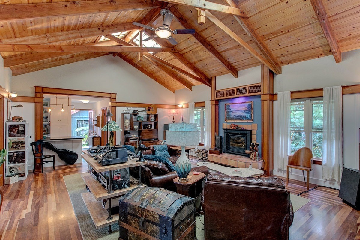 19-4242 Wright Road Volcano, HI 96785 - Photo 2 of 30 a living room with furniture a fireplace and wooden floor