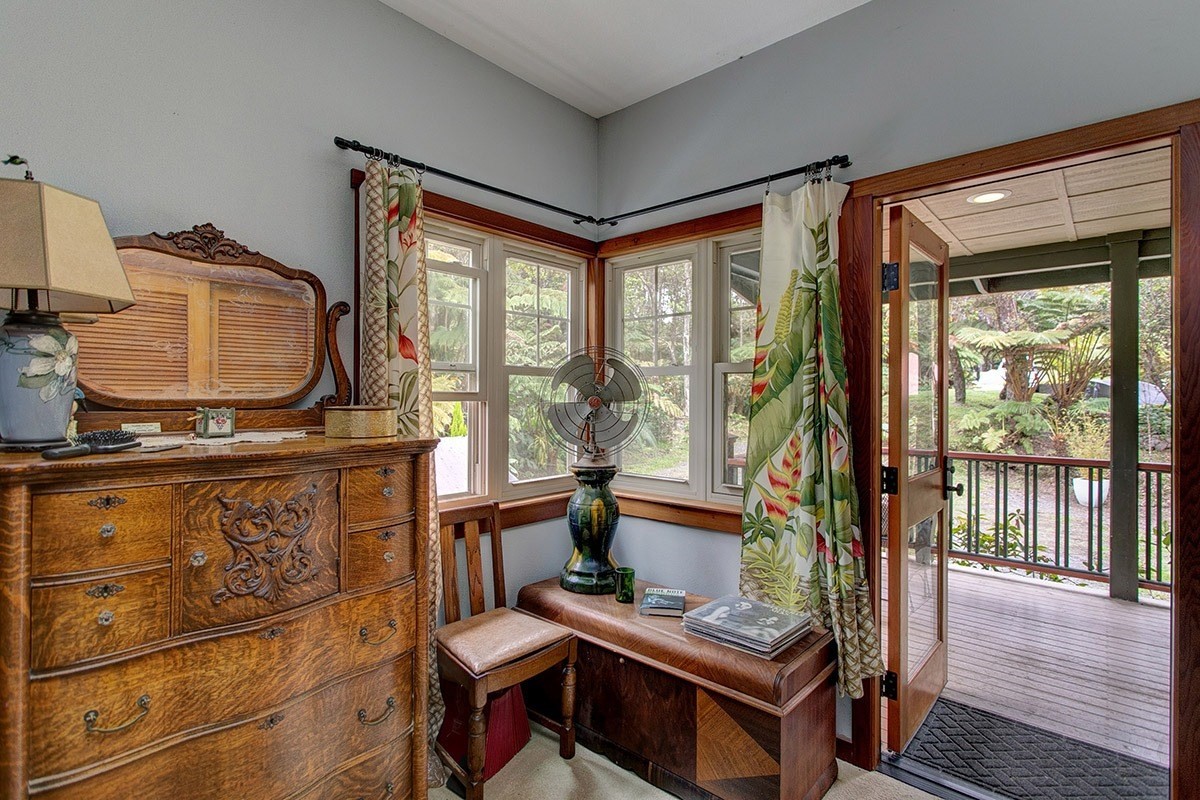 19-4242 Wright Road Volcano, HI 96785 - Photo 23 of 30 a living room with furniture a flat screen tv and a floor to ceiling window