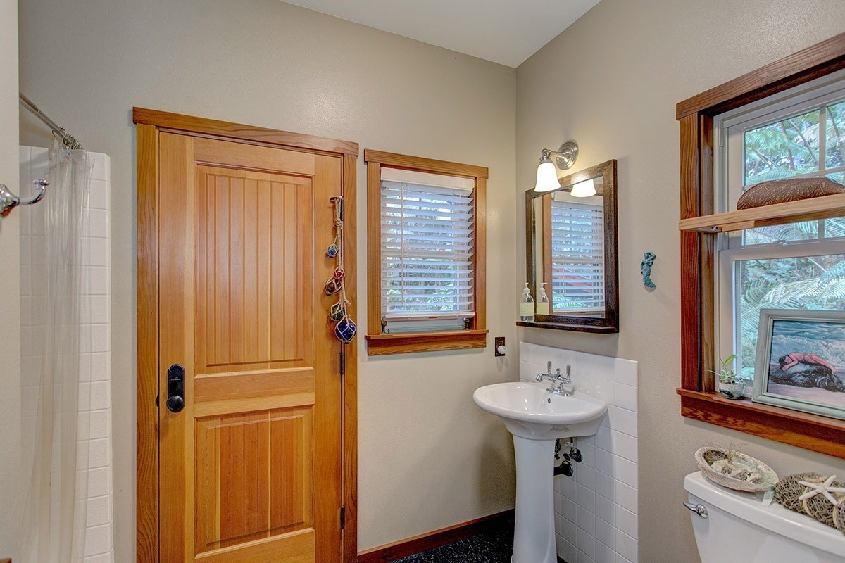 19-4242 Wright Road Volcano, HI 96785 - Photo 24 of 30 a bathroom with a sink a mirror and a window