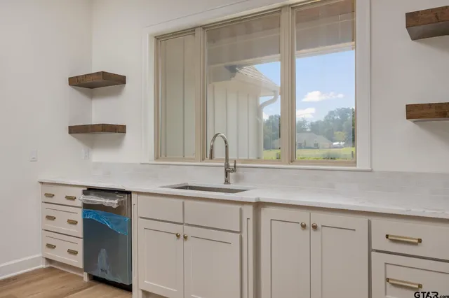 a kitchen with a sink and a window