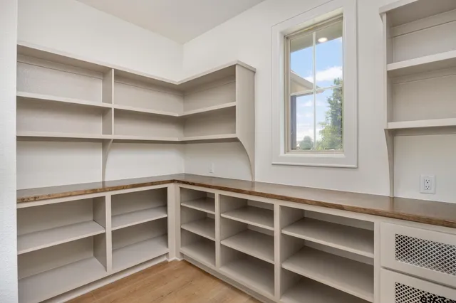 a view of walk in closet with empty racks