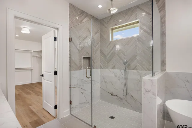 a bathroom with a bathtub and a shower