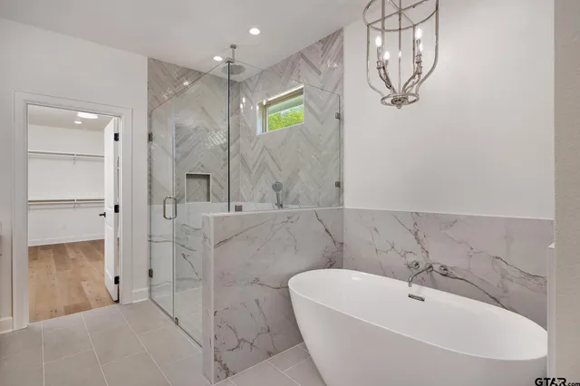 a bathroom with a bathtub and shower