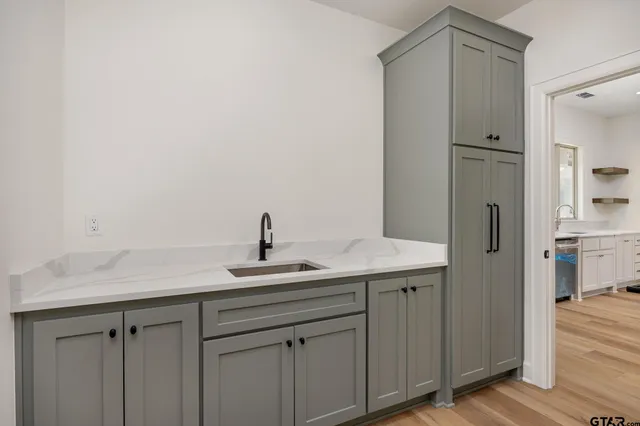 a kitchen with a sink and refrigerator