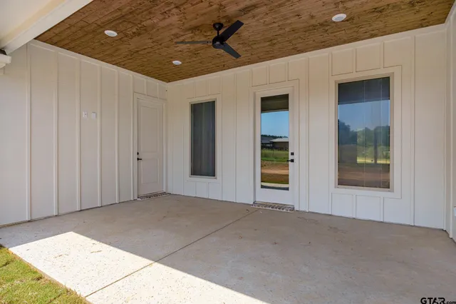 a spacious bathroom with a mirror and a shower