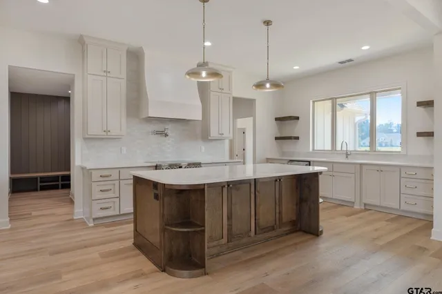 a kitchen with a sink stove and cabinets